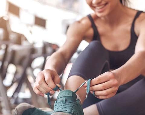 A woman tying her shoes